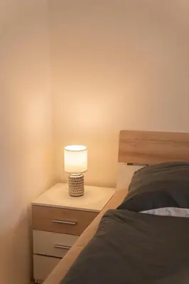 a bedroom with a bed and a lamp on a night stand at FREE PARKING- Cozy apartment in historical building center Prague in Prague