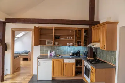 a kitchen with wooden cabinets and a stove top oven at FREE PARKING- Cozy apartment in historical building center Prague in Prague