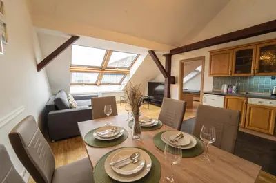 a dining room with a table and chairs and a kitchen at FREE PARKING- Cozy apartment in historical building center Prague in Prague