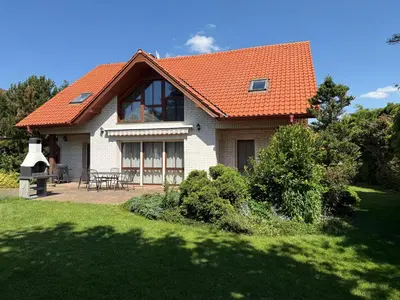 a house with an orange roof on a yard at Vila Berlin in Prague