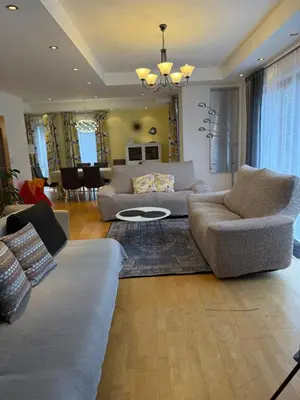 a living room with couches and a dining room at Vila Berlin in Prague