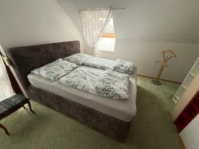 a bedroom with a bed and a window at Vila Berlin in Prague