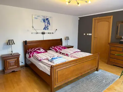 a bedroom with a bed with red and white pillows at Vila Berlin in Prague