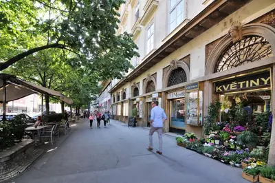 a man riding a skateboard down a city street at Prague OLD TOWN Cozy Luxury Apartman in Heart of City in Prague