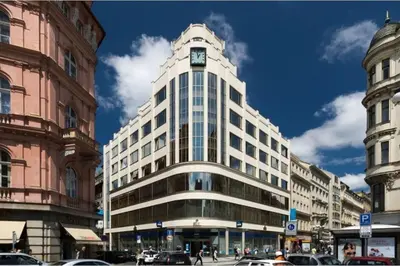 a tall white building with a clock on top of it at Prague OLD TOWN Cozy Luxury Apartman in Heart of City in Prague