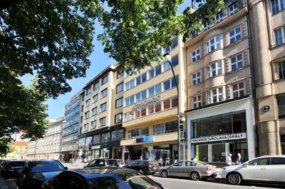 a street with cars parked in front of a building at Prague OLD TOWN Cozy Luxury Apartman in Heart of City in Prague