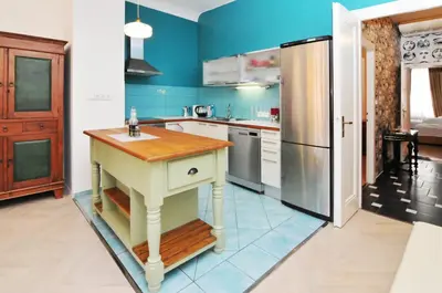 a kitchen with a table and a refrigerator at Prague OLD TOWN Cozy Luxury Apartman in Heart of City in Prague