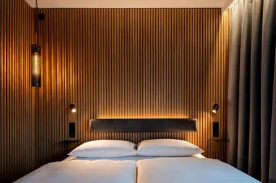 a bedroom with a large bed with white pillows at Zleep Hotel Prague in Prague