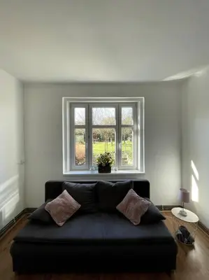 a living room with a couch and a table at Dům Na Polabí in Mělník