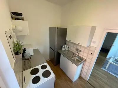 a bed in a white room with two night stands at Dům Na Polabí in Mělník