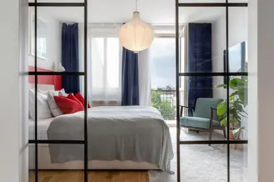 a living room with a glass wall at TurnKey I Charles Square Apartments in Prague