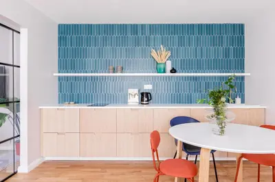 a kitchen with white cabinets and a sink at TurnKey I Charles Square Apartments in Prague
