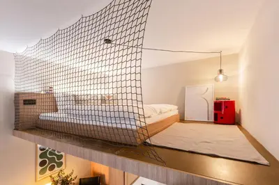 a living room with a couch and a bed at TurnKey I Charles Square Apartments in Prague