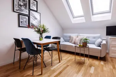 a bed with colorful pillows and a table on it at TurnKey I Charles Square Apartments in Prague