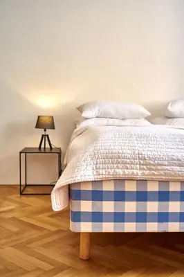 a bedroom with a bed and a table with a lamp at Apartmán III Praha - centrum in Prague