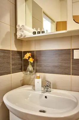 a bathroom with a white sink and a mirror at Apartmán III Praha - centrum in Prague