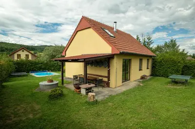 a small house in a yard with a pool at Chalupa Měňany - Karlštejn in Beroun