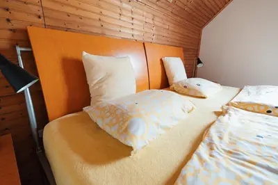 a bedroom with two beds and a headboard at Chalupa Měňany - Karlštejn in Beroun