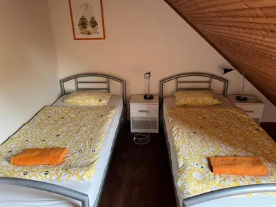 two beds sitting next to each other in a bedroom at Chalupa Měňany - Karlštejn in Beroun