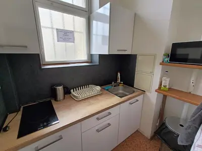 a kitchen counter with a sink and a window at A Plus Hostel - Centrum in Prague