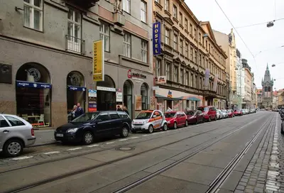 a row of cars parked on the side of a city street at A Plus Hostel - Centrum in Prague