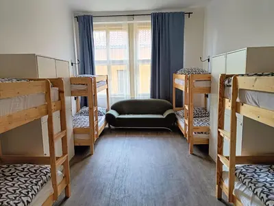 a room with four bunk beds and a window at A Plus Hostel - Centrum in Prague