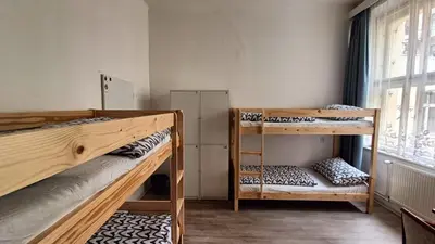 a room with two bunk beds and a window at A Plus Hostel - Centrum in Prague
