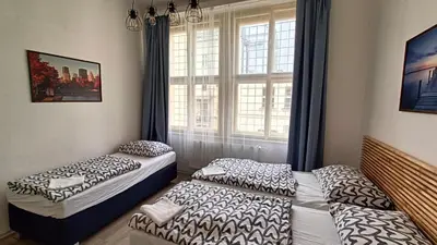 two beds in a room with a window at A Plus Hostel - Centrum in Prague