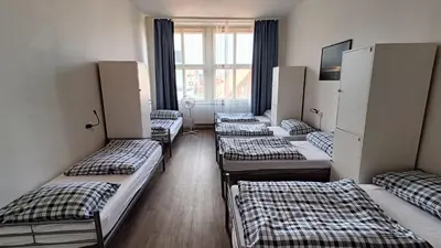 a row of beds in a room with a window at A Plus Hostel - Centrum in Prague