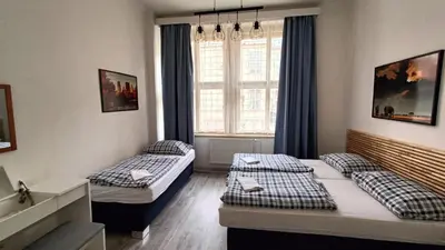 a hotel room with two beds and a window at A Plus Hostel - Centrum in Prague