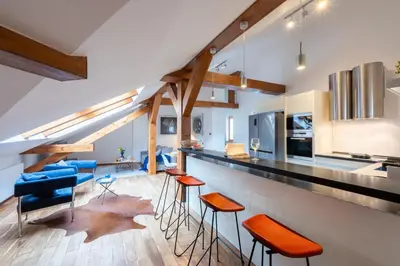 a dining room with a wooden table and chairs at Prague Days - SAttic Apartment with AC next to Old Town Square in Prague
