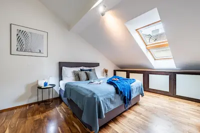 a bedroom with a bed and a skylight at Prague Days - SAttic Apartment with AC next to Old Town Square in Prague