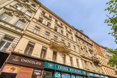 a large building with a sign in front of it at Prague Days - SAttic Apartment with AC next to Old Town Square in Prague