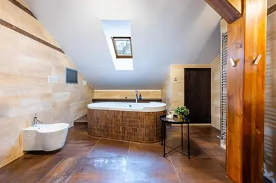 a bathroom with a tub and a sink at Prague Days - SAttic Apartment with AC next to Old Town Square in Prague