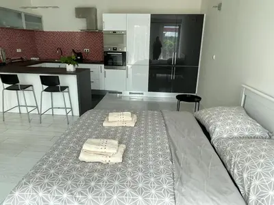 a bedroom with a bed with two towels on it at RUMAKO apartments in Prague