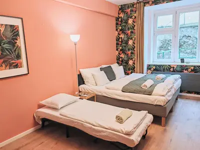 a bedroom with two beds and a window at Zizkov studio -004- in Prague