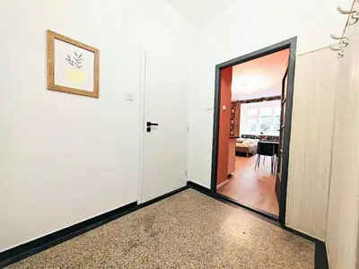 a hallway with a door leading to a dining room at Zizkov studio -004- in Prague