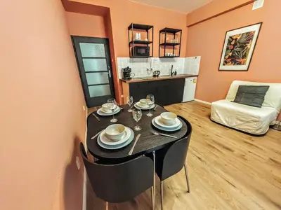 a dining room with a table and a couch at Zizkov studio -004- in Prague