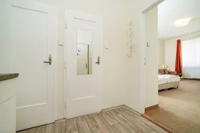 a room with a white door and a bedroom at Modern, bright studio in a great location in Prague