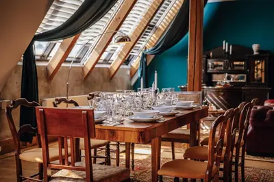 a wooden table with glasses and plates on it at Prague Castle King's Chic in Prague