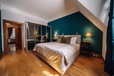 a bedroom with a bed and a green wall at Prague Castle King's Chic in Prague