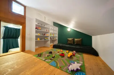 a childs bedroom with a toy train on a rug at Prague Castle King's Chic in Prague