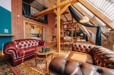 a living room with leather couches and a table at Prague Castle King's Chic in Prague