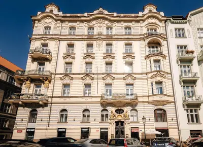 a large building with cars parked in front of it at Prague Castle King's Chic in Prague