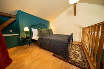 a bedroom with a bed and a blue wall at Chateau Charme - Prague centre in Prague