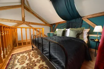 a bedroom with a bed in a room with beams at Chateau Charme - Prague centre in Prague