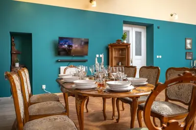 a dining room with a wooden table and chairs at Chateau Charme - Prague centre in Prague