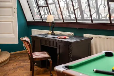 a table with a lamp next to a pool table at Chateau Charme - Prague centre in Prague