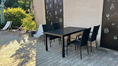 a black table and chairs on a patio at Chatka Jägerhaus K myslivně 26 in Libochovice