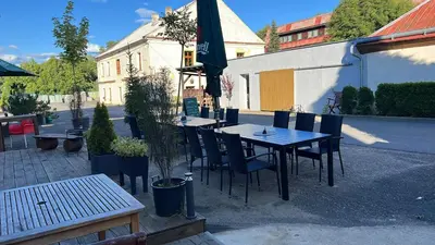a table and chairs sitting in front of a building at Chatka Jägerhaus K myslivně 26 in Libochovice